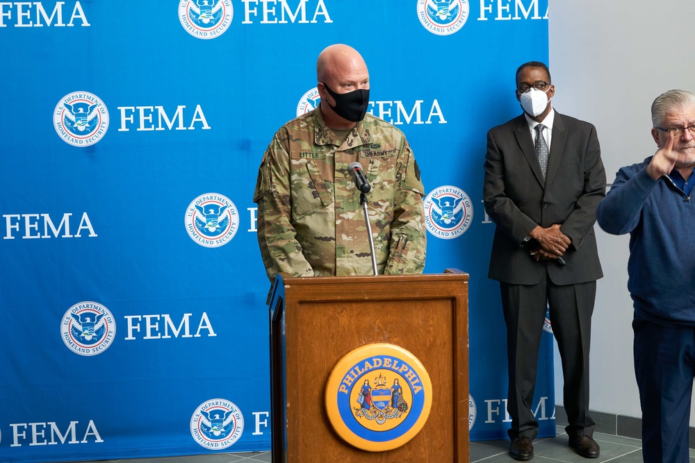 Dual Status Commander speaks to local media at the Esperanza Community Vaccination Center in Philadelphia