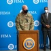 Dual Status Commander speaks to local media at the Esperanza Community Vaccination Center in Philadelphia