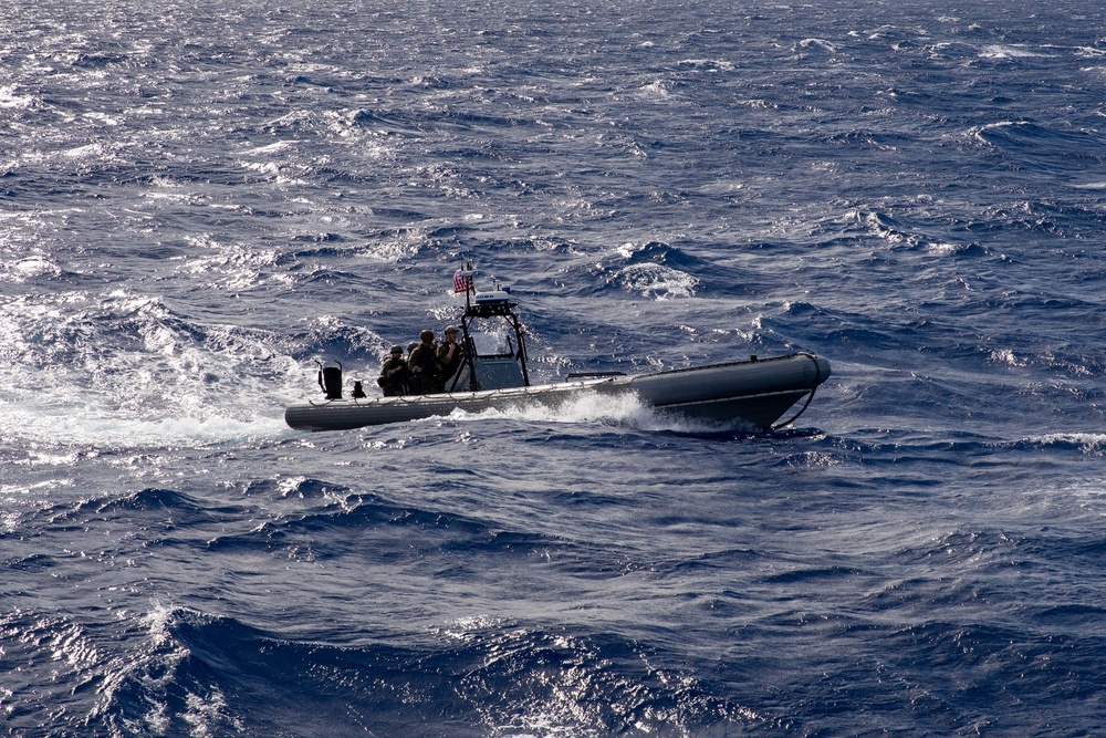 Coast Guardsmen and Sailors participate in an aerial use of force (AUF) exercise