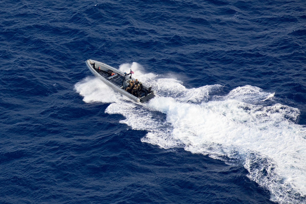 Coast Guardsmen and Sailors participate in an aerial use of force (AUF) exercise