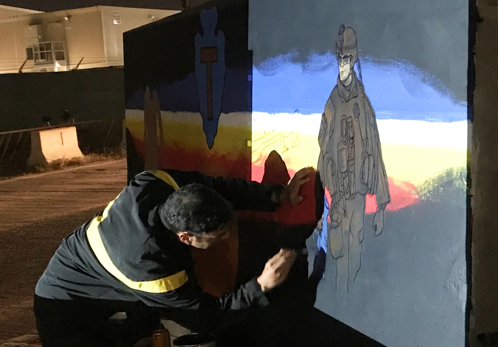 Task Force Spartan Soldier paints T-wall after winning design competition