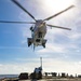 USS Barry conducts a vertical-replenishment with a Puma helicopter, assigned to USNS Charles Drew