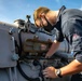 Gunners Mate Seaman John Rametta conducts maitenance on a torpedo launcher aboard USS Barry