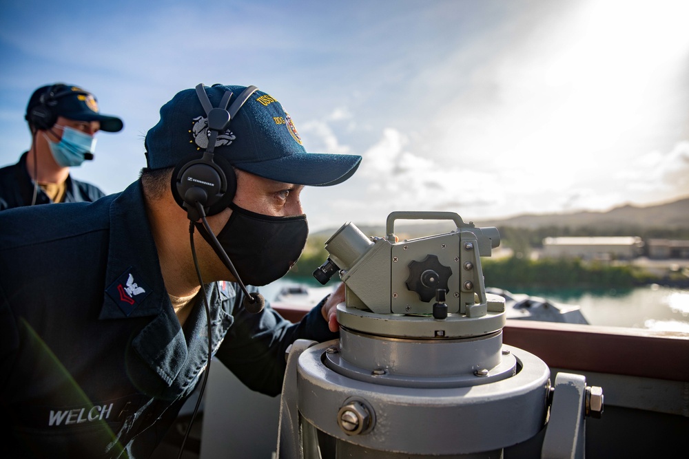 Quartermaster 2nd Class Kenny Welch prepares to take the navigation bearing aboard the USS Barry