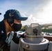 Quartermaster 2nd Class Kenny Welch prepares to take the navigation bearing aboard the USS Barry