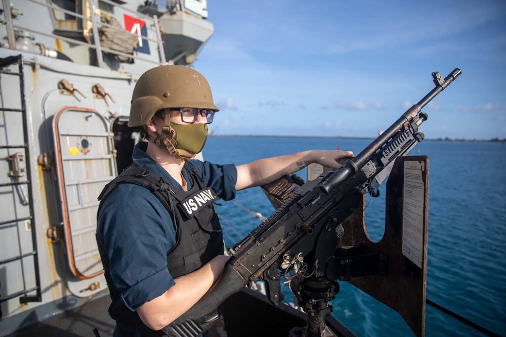 Fire Controlman 2nd Class Jacob Lugviel mans the .50-cal during a sea and anchor detail aboard the USS Barry