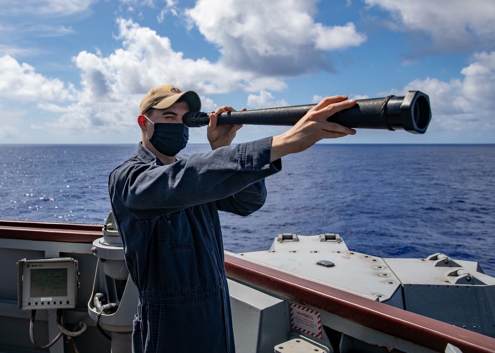 Lt. j.g. Sam Hardgrove scans the sea for any surface contacts aboard the USS Barry