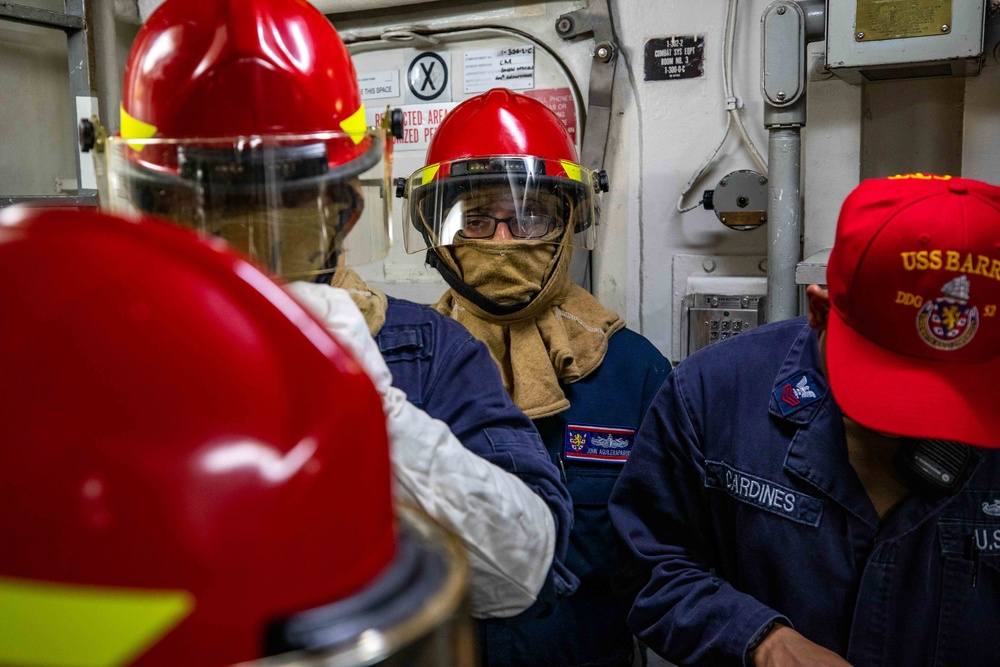 Sailors aboard the USS Barry conduct firefighting drills