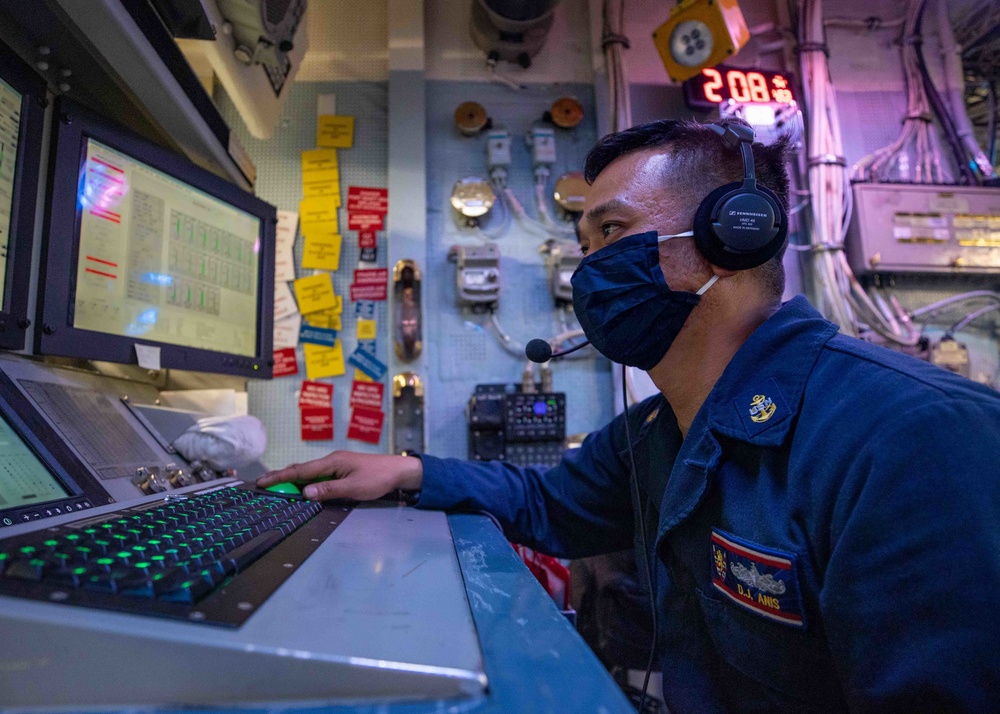 Gas Turbine System Mechanic Chief D.J. Anis, mans the propulsion auxiliary control console aboard the USS Barry