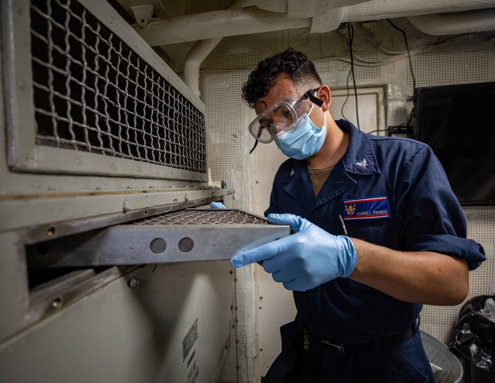 Operations Specialist 3rd Class Gabriel Franco conducts maitenance aboard the USS Barry