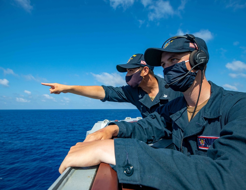 Boatswain's Mate's aboard the USS Barry stand the lookout watch during routine underway operations