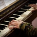 Swiss KFOR soldier plays piano at Bondsteel chapel