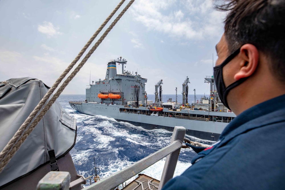USS Barry conducts a replenishment-at-sea with USNS Pecos
