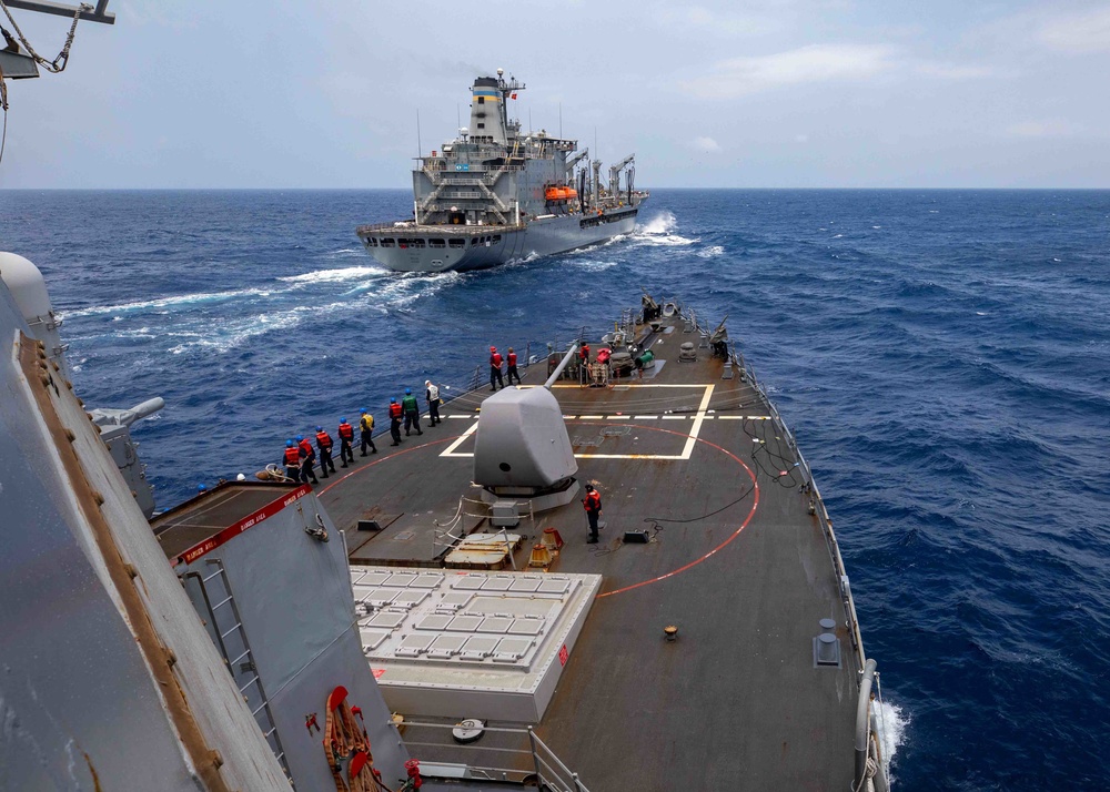 USS Barry conducts a replenishment-at-sea with USNS Pecos