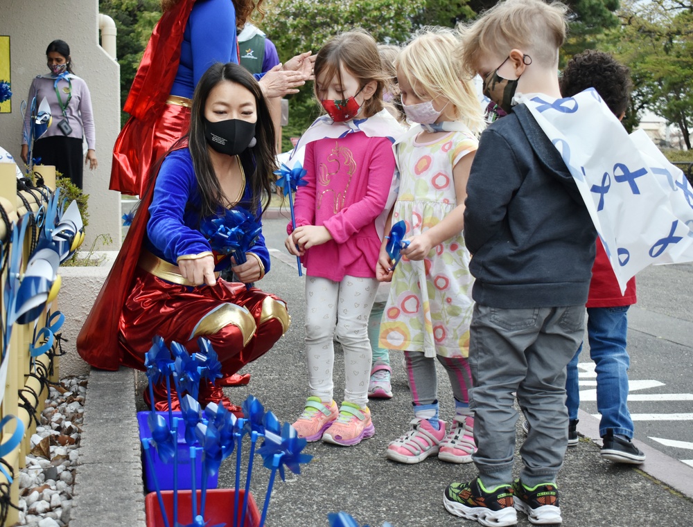 Camp Zama FMWR honors military children with superhero parade, pinwheel planting