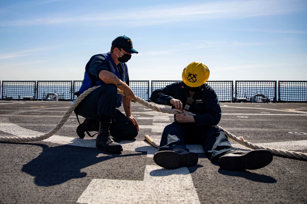 Sailors assigned to the Freedom-variant littoral combat ship USS Sioux City (LCS 11) repair lines on the ship’s flight deck