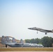F-15 Eagle passes line full of C-130 Hercules aircraft