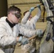 Photo of Team JSTARS personnel scrubbing aircraft in ISO Dock
