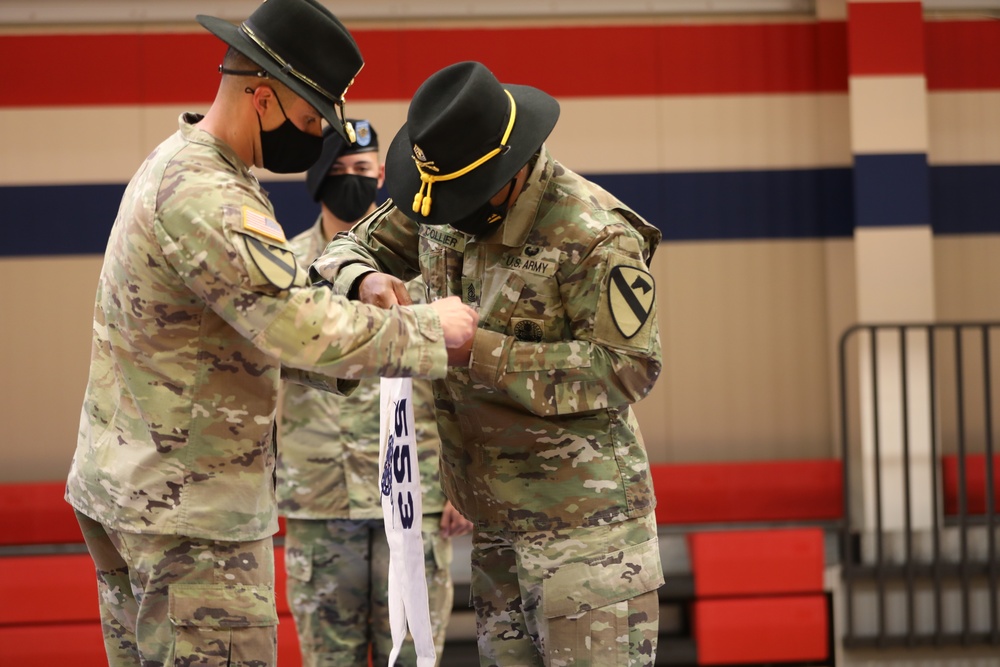 Capt. Austin Harper and 1st Sergeant Jonathan Collier remove the old 289th Supply Company guidon and install the new A Company guidon during the 553rd Division Sustainment Support Battalion conversion ceremony April 16 at Fort Hood.