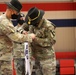 Capt. Austin Harper and 1st Sergeant Jonathan Collier remove the old 289th Supply Company guidon and install the new A Company guidon during the 553rd Division Sustainment Support Battalion conversion ceremony April 16 at Fort Hood.