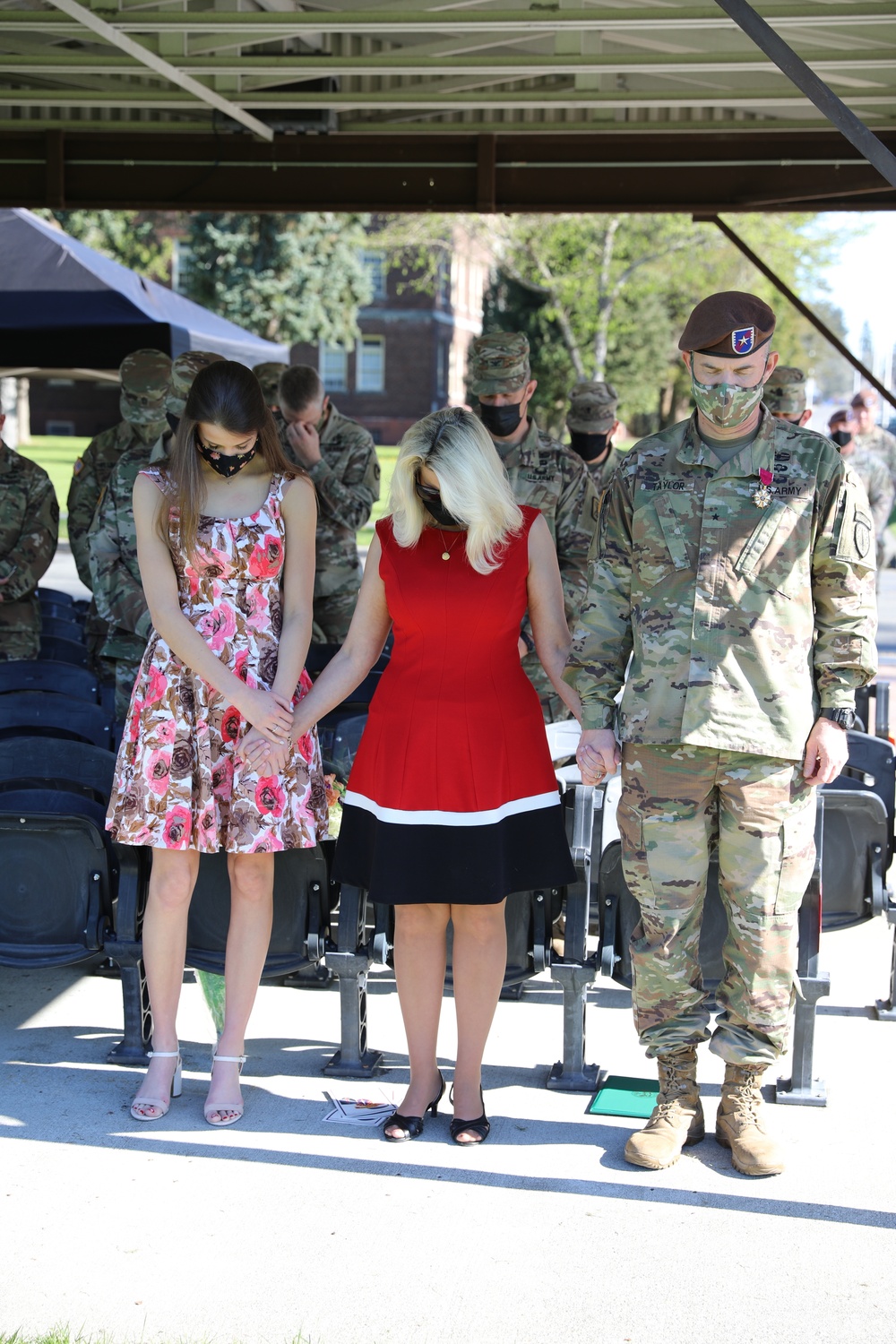 Taylor Family pauses in prayer during Relinquishment of Command Ceremony