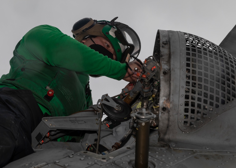 Sailor Perform Maintenance on MH-60S Sea Hawk