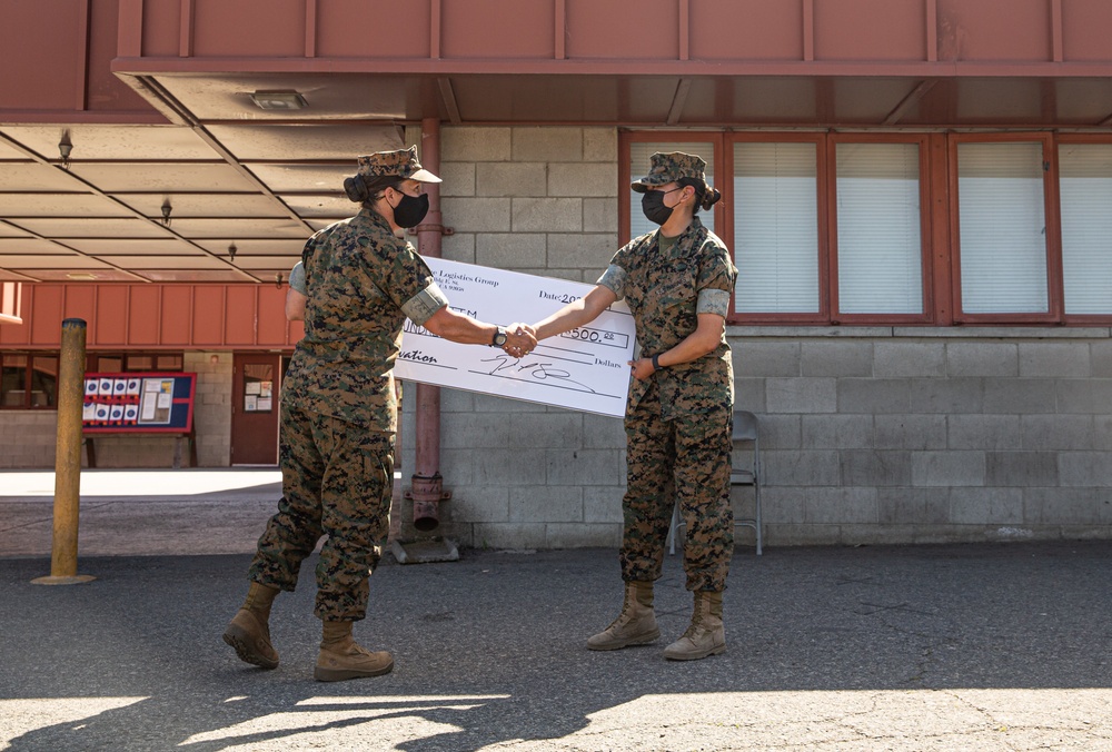 1st Transportation Battalion Marine receives check for Innovation Award