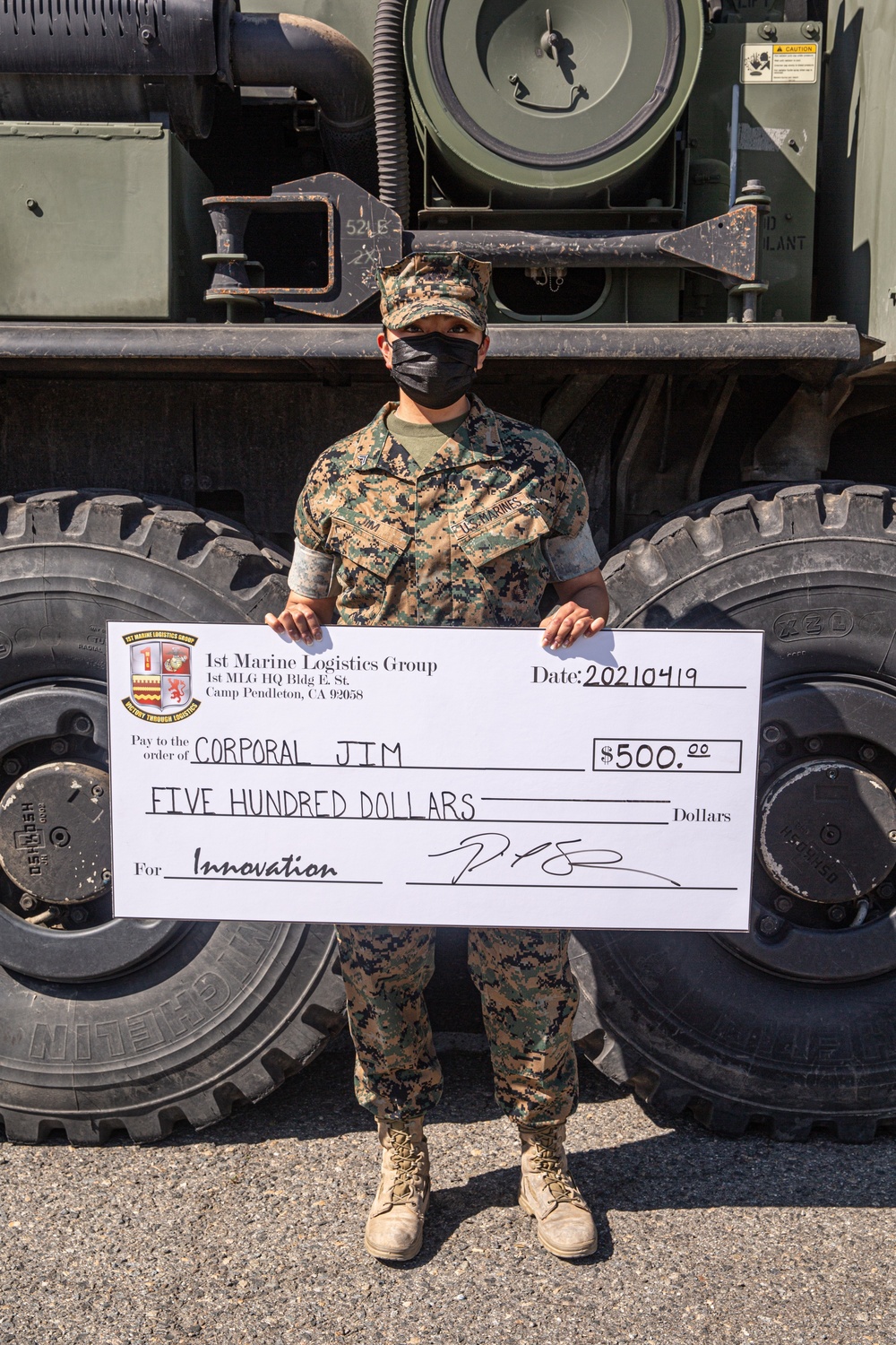 1st Transportation Battalion Marine receives check for Innovation Award