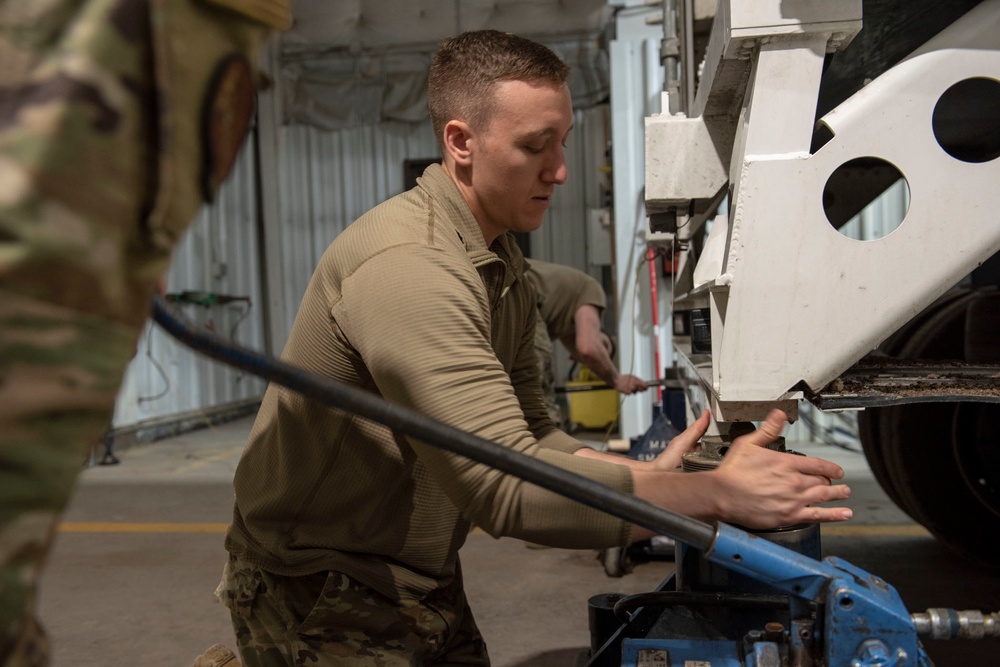 Missile handling technicians complete roll transfer during QA inspection