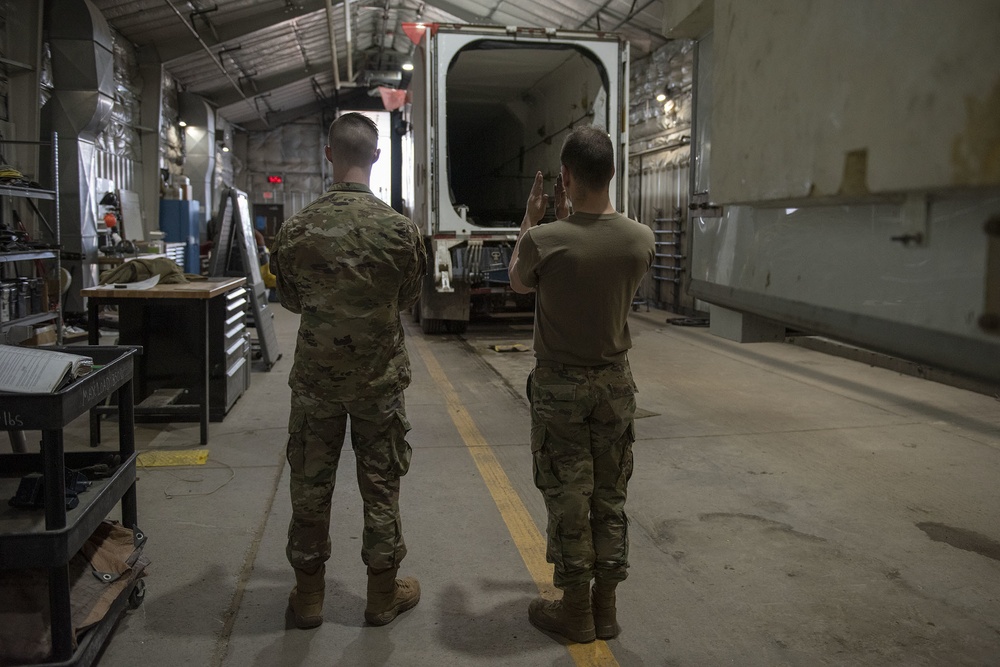 Missile handling technicians complete roll transfer during QA inspection