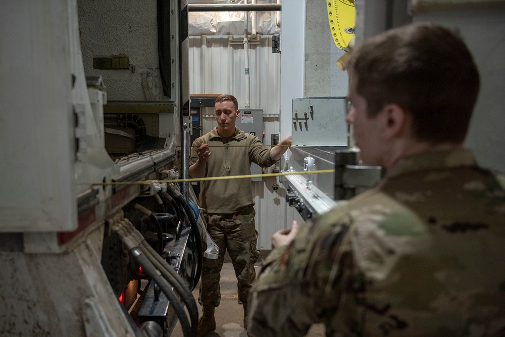 Missile handling technicians complete roll transfer during QA inspection