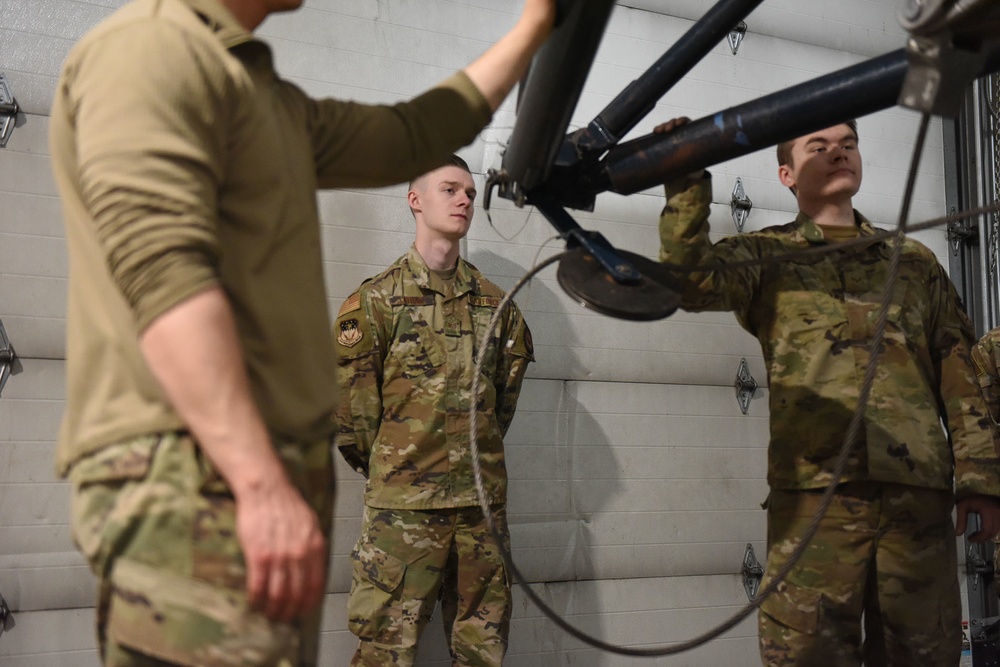 Missile handling technicians complete roll transfer during QA inspection