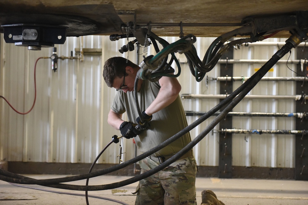 Missile handling technicians complete roll transfer during QA inspection