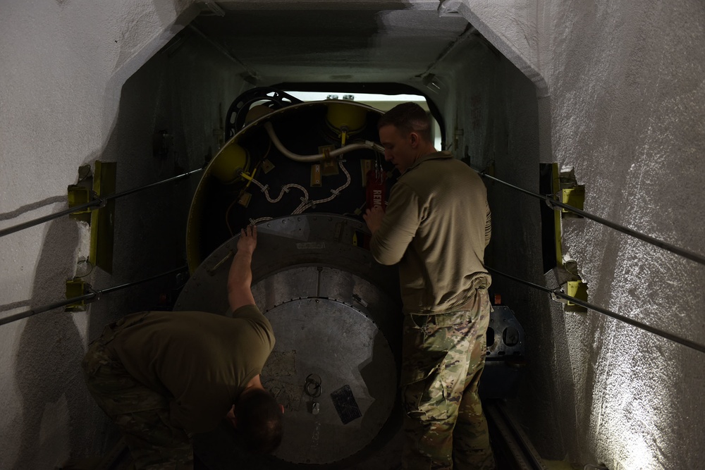 Missile handling technicians complete roll transfer during QA inspection