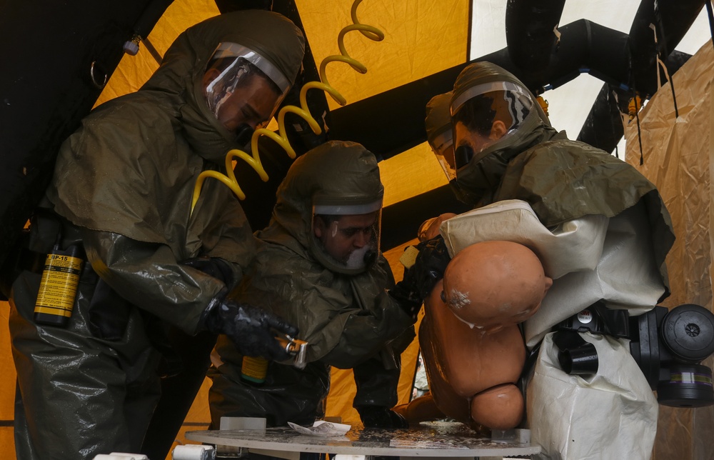 Airmen team up, complete decontamination training