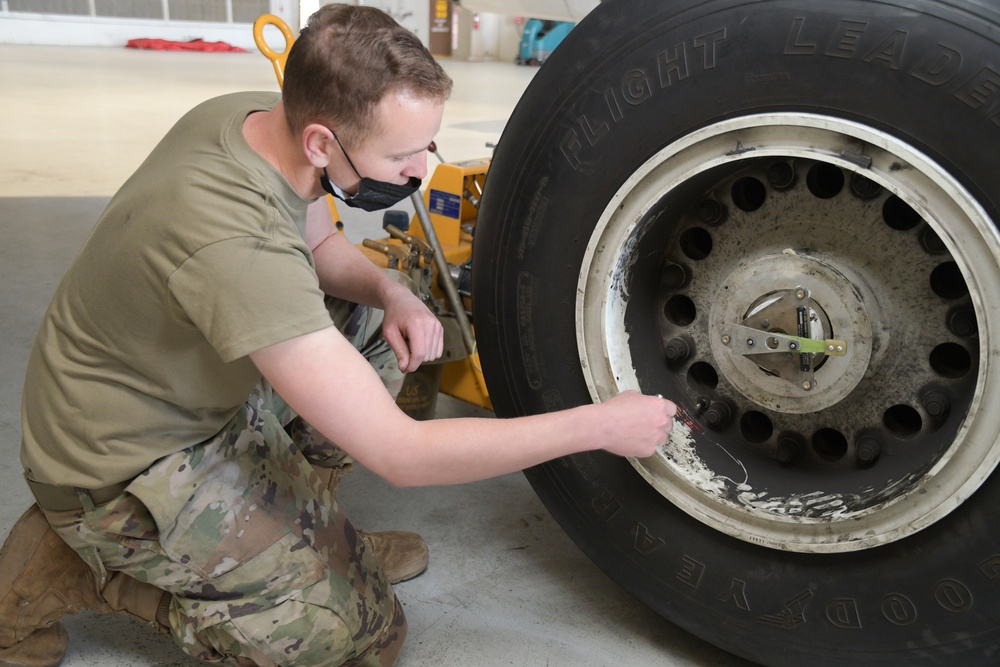 Photo of 461st Crew Chiefs changing aircraft wheel and tire