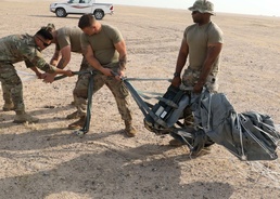 1st TSC Soldiers successfully precision-airdrops GPS-guided pallets in Kuwait test
