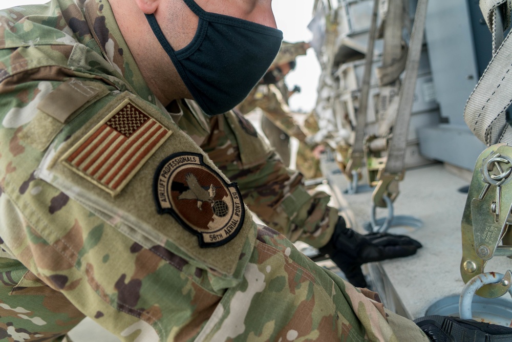 Aircrew from the 349th AMW move cargo as a part of exercise Nexus Dawn