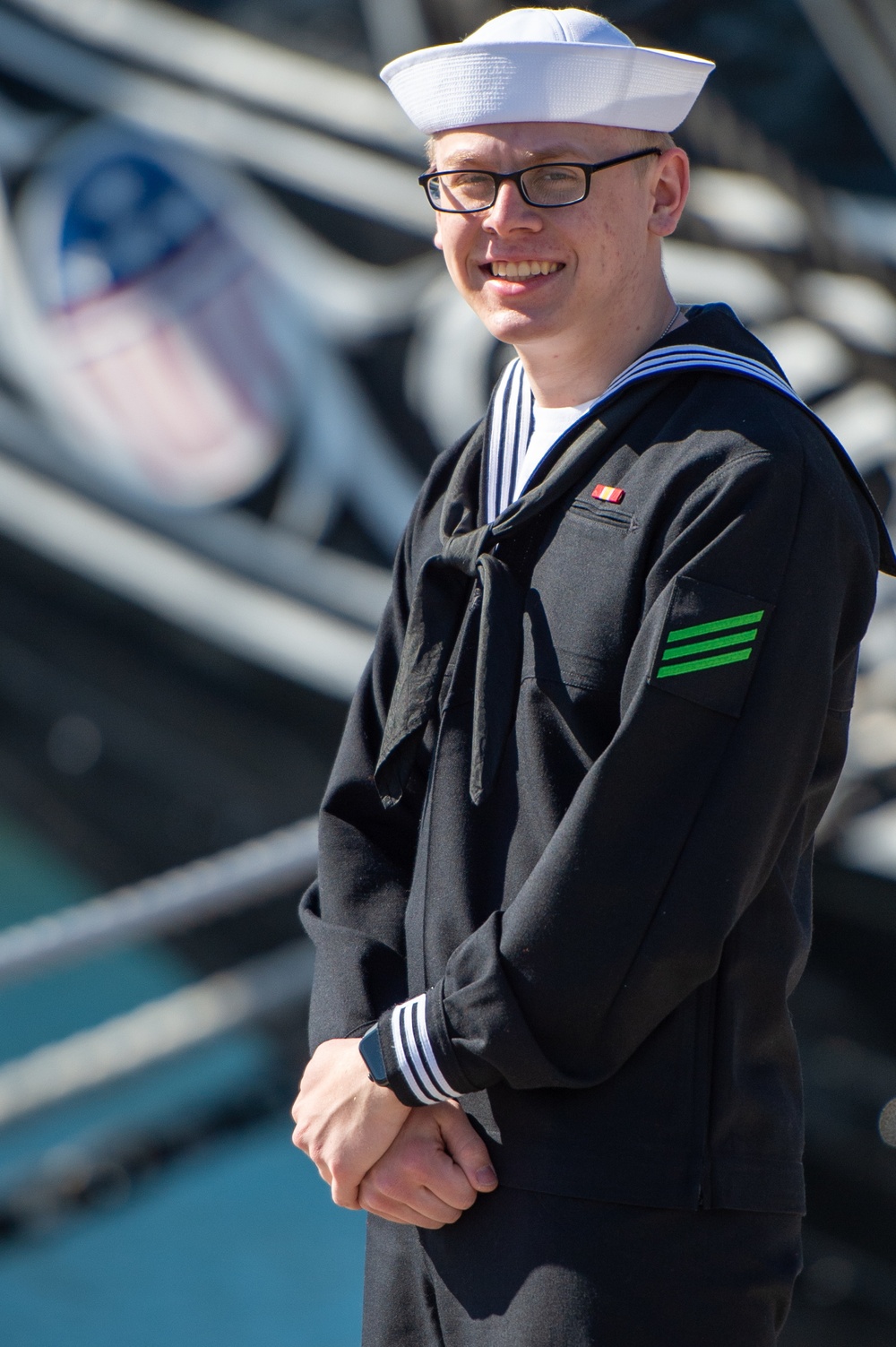 AN Adam Cluckie poses for a photo in front of USS Constitution