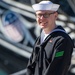 AN Adam Cluckie poses for a photo in front of USS Constitution