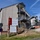 U.S. Army Corps of Engineers manages building renovation projects at the Baumholder Military Community A construction/renovation site at Smith Barracks in Baumholder, Germany, managed by the US Army Corps of Engineers, Europe. The project involves renovating Buildings 8225/8226, with a project start date of 30-11-2020. A prominent safety sign and contractor signage (KLEBL) are visible in the foreground.