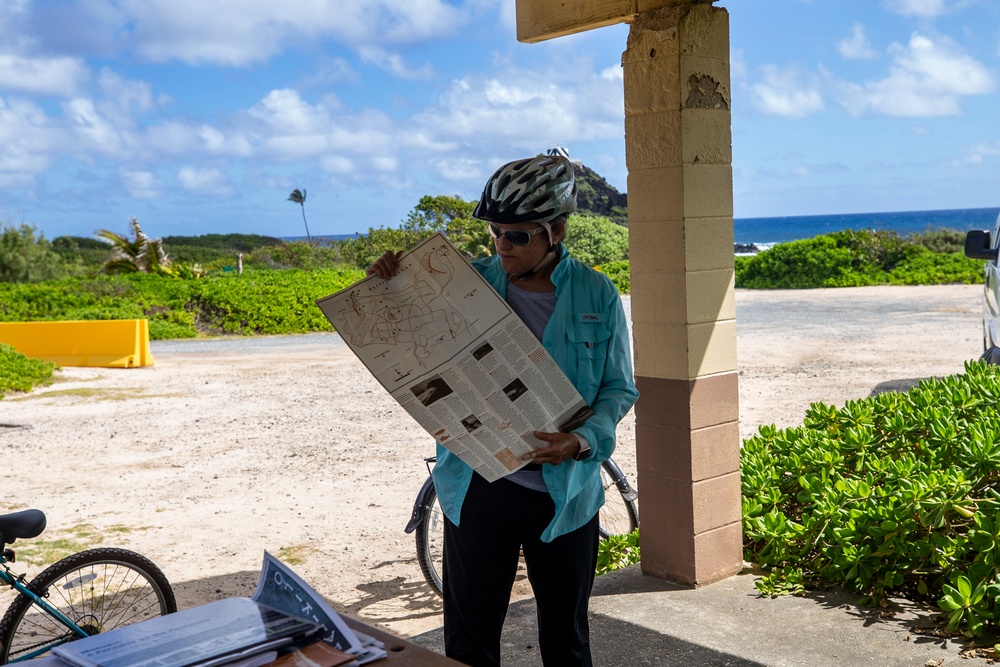 June Cleghorn, cultural resource manager, Marine Corps Base Hawaii, holds up a map of the Mokapu Cultural Sites Bike Tour, MCBH, April 23, 2021