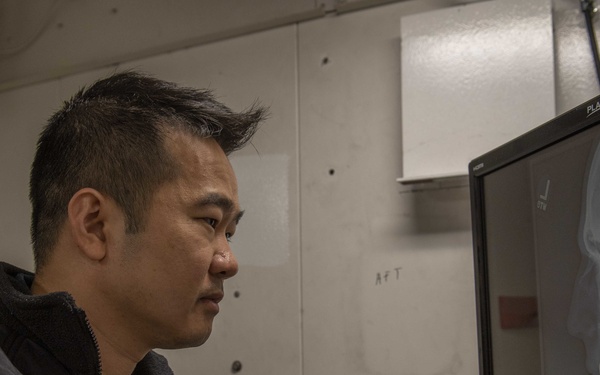 GHWB Sailor Looks at an X-Ray