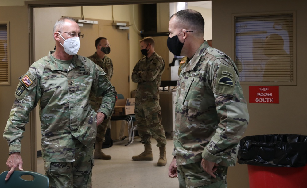 Maj. Gen. Michael C. O' Guinn talks with  Brig. Gen. Walter M. Duzzny at a private lunch