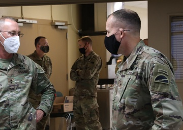 Maj. Gen. Michael C. O' Guinn talks with  Brig. Gen. Walter M. Duzzny at a private lunch