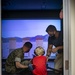 Service members and their families participate in the bring your kid to work day event