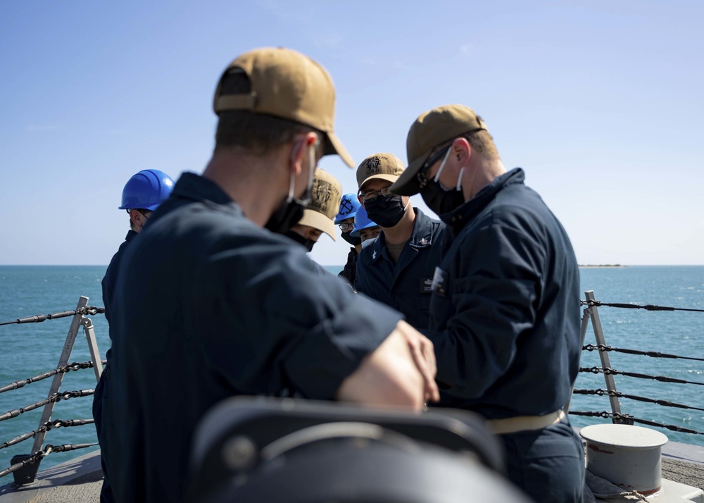 Sailors Lower the Jackstaff Aboard USS Sioux City