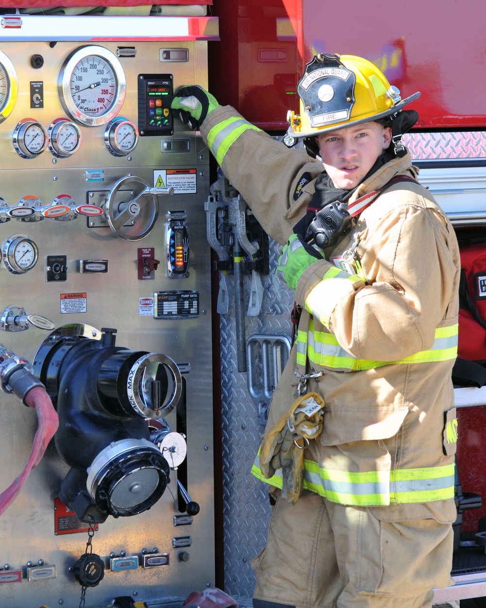 Senior Airman Benjamin McDermott, 185th Air Refueling Wing Fire Department, monitors the controls on the firetruck during a Federal Aviation Administration mass casualty exercise held at the Sioux Gateway airport/Col. Bud Day Field, on May 1, 2021.  U.S.