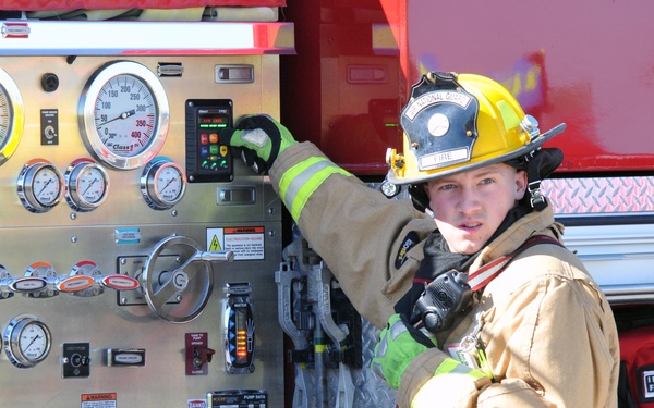 Senior Airman Benjamin McDermott, 185th Air Refueling Wing Fire Department, monitors the controls on the firetruck during a Federal Aviation Administration mass casualty exercise held at the Sioux Gateway airport/Col. Bud Day Field, on May 1, 2021.  U.S.