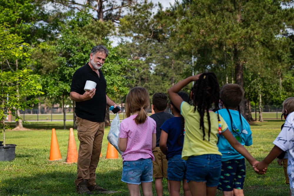 Airmen, children plant tree for Arbor Day